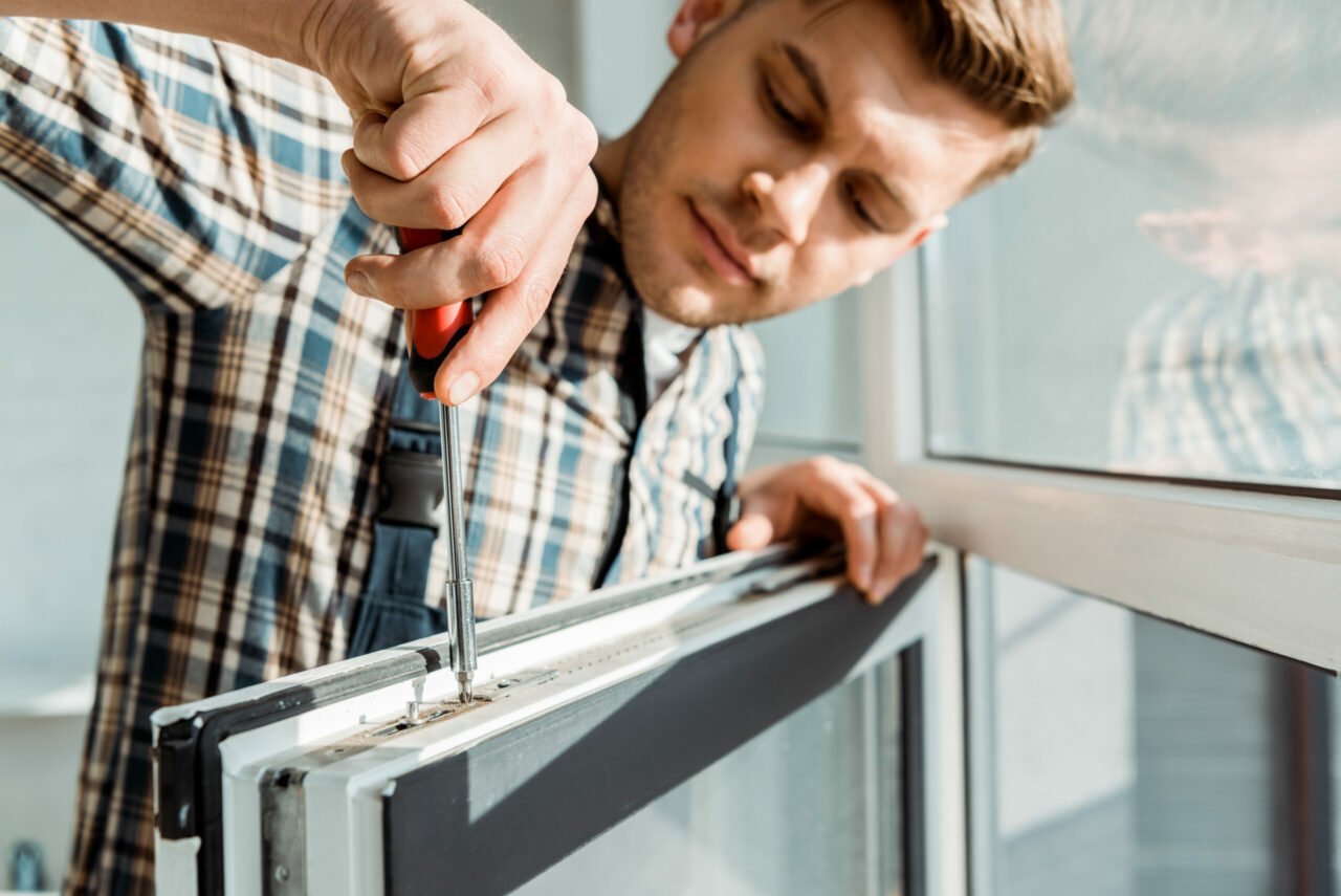 A young man replacing windows